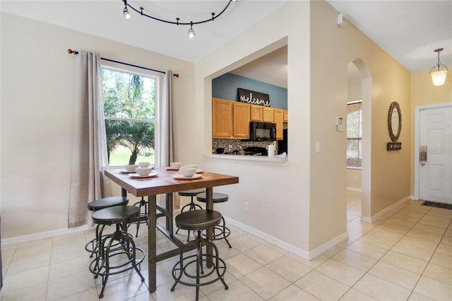 dining space featuring light tile patterned floors