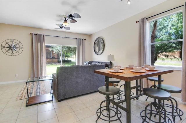 dining space with ceiling fan, light tile patterned floors, and a healthy amount of sunlight