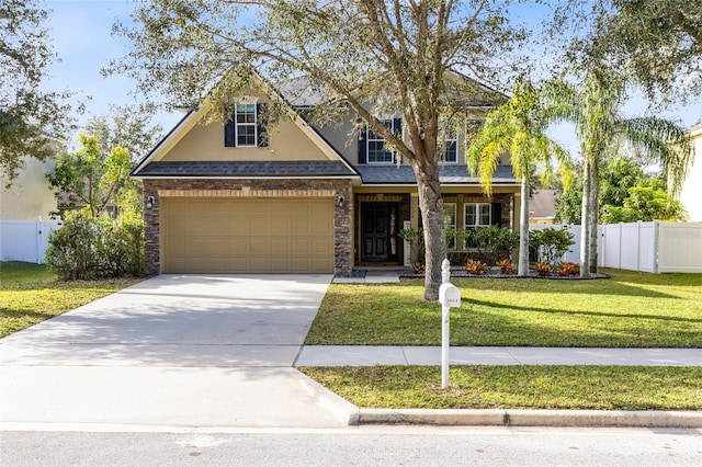 view of front of house with a front yard and a garage