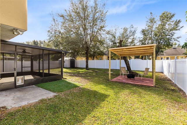 view of yard with a sunroom and a patio