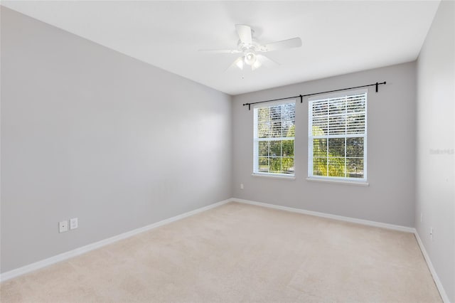 empty room featuring light carpet and ceiling fan