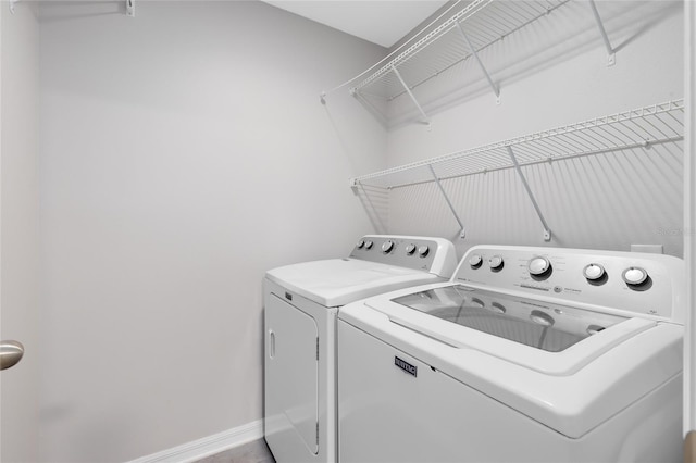 clothes washing area featuring separate washer and dryer