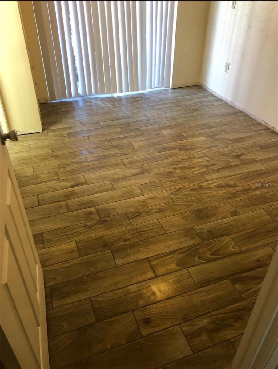 empty room with hardwood / wood-style flooring