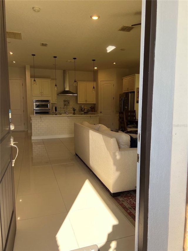 living room featuring tile patterned floors and sink