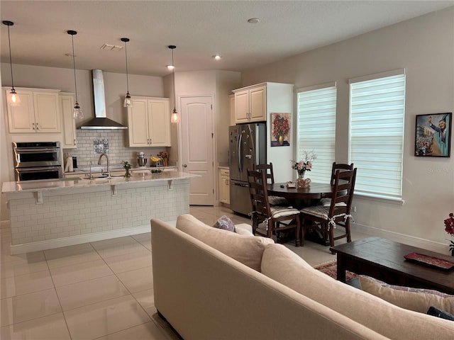 living room with sink and light tile patterned floors