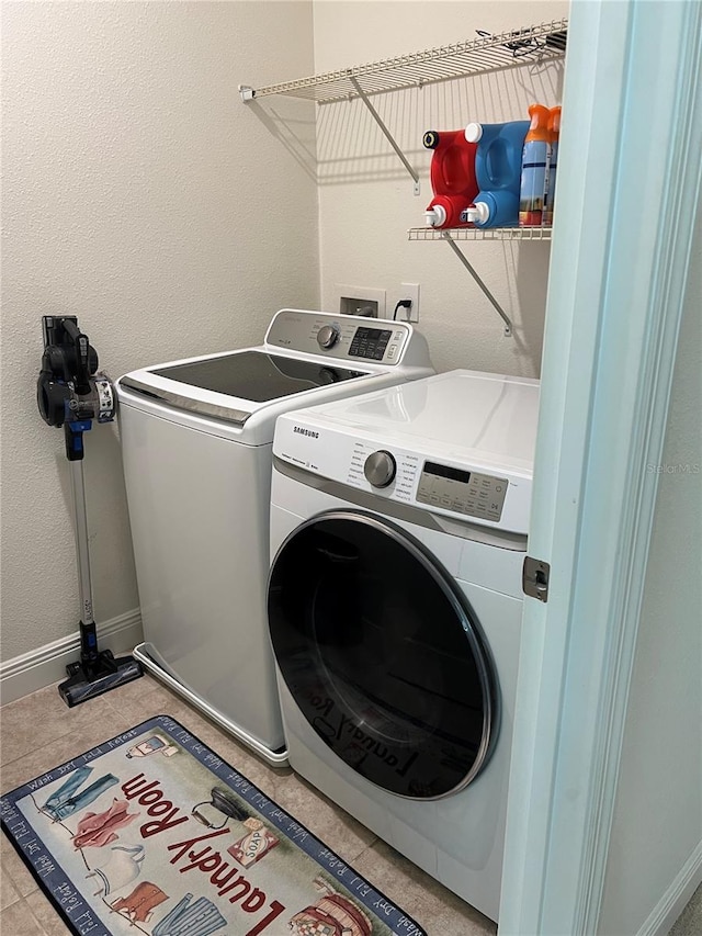 washroom with tile patterned floors and washing machine and dryer