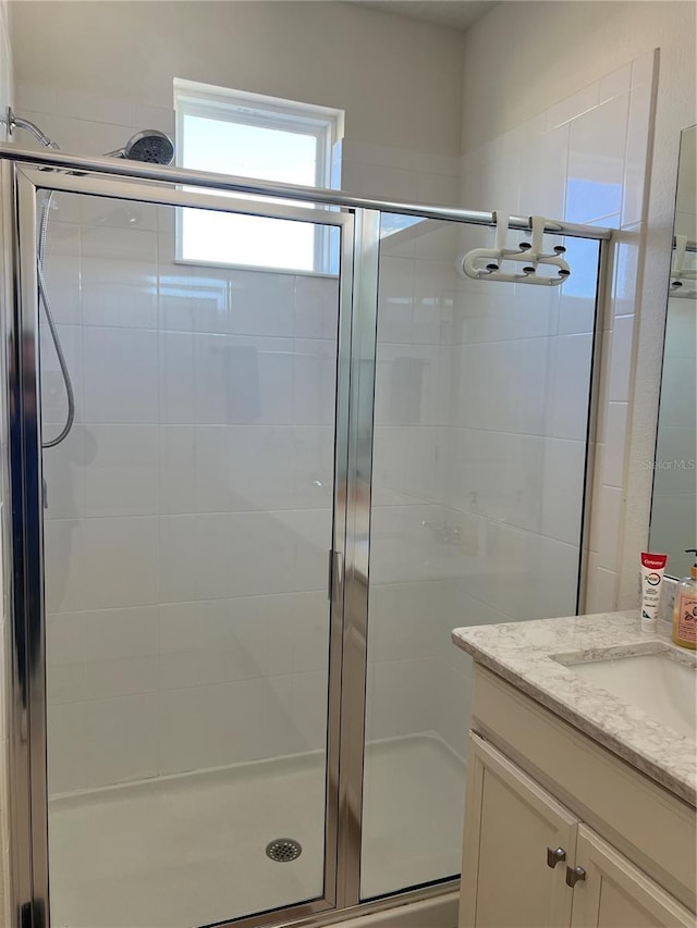 bathroom with vanity and walk in shower