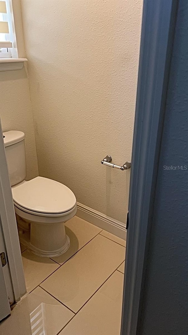 bathroom with tile patterned floors and toilet