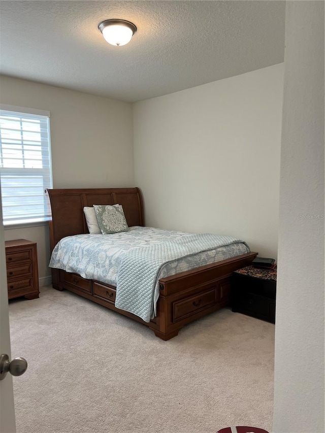 carpeted bedroom with a textured ceiling