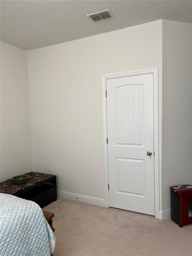 bedroom with light colored carpet