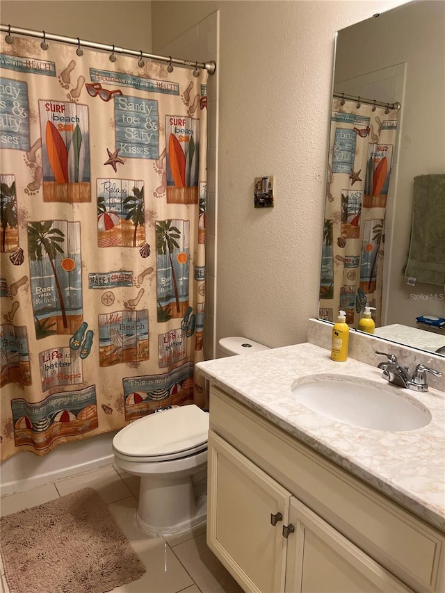 bathroom featuring tile patterned flooring, vanity, and toilet