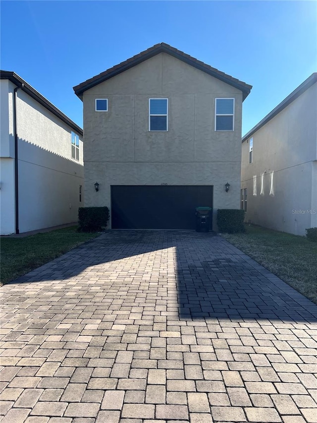 rear view of house featuring a garage