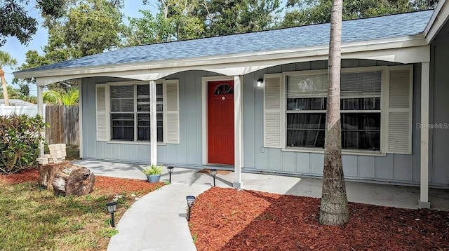 view of exterior entry featuring a porch