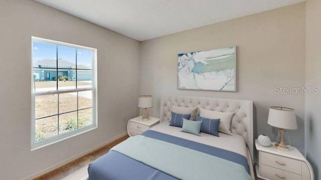 bedroom featuring carpet flooring and multiple windows