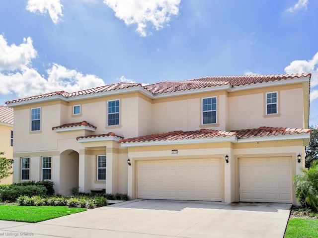 mediterranean / spanish-style house with a garage