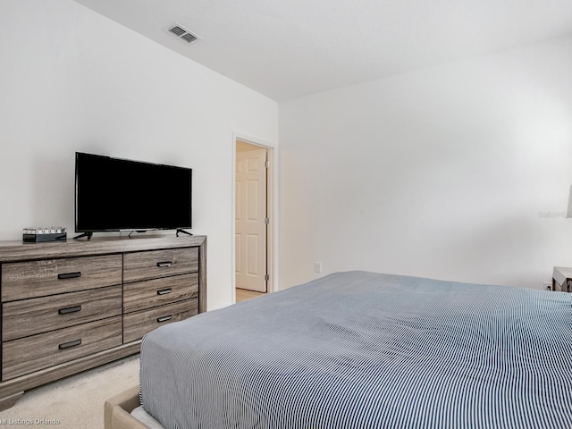 bedroom featuring light colored carpet