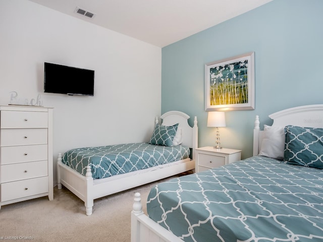 bedroom with light colored carpet