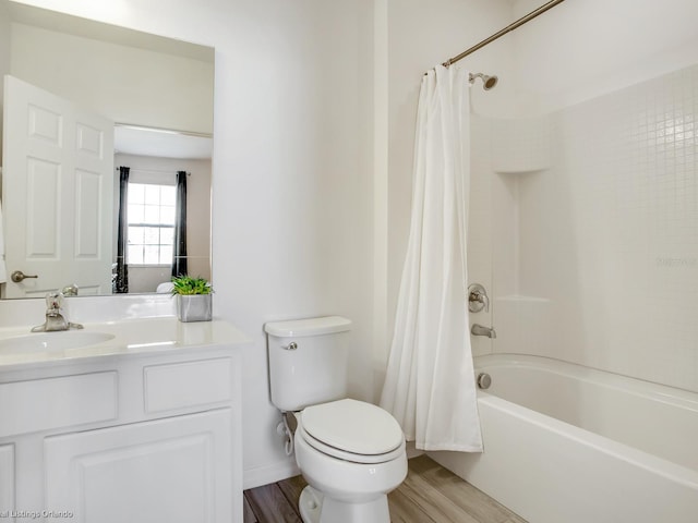 full bathroom featuring toilet, shower / tub combo with curtain, vanity, and hardwood / wood-style flooring