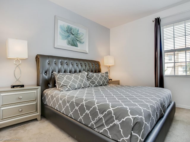 bedroom featuring light carpet