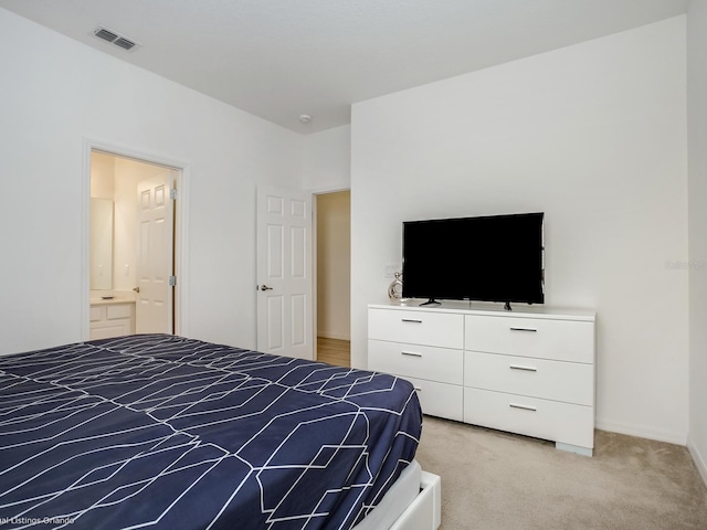 carpeted bedroom featuring ensuite bathroom