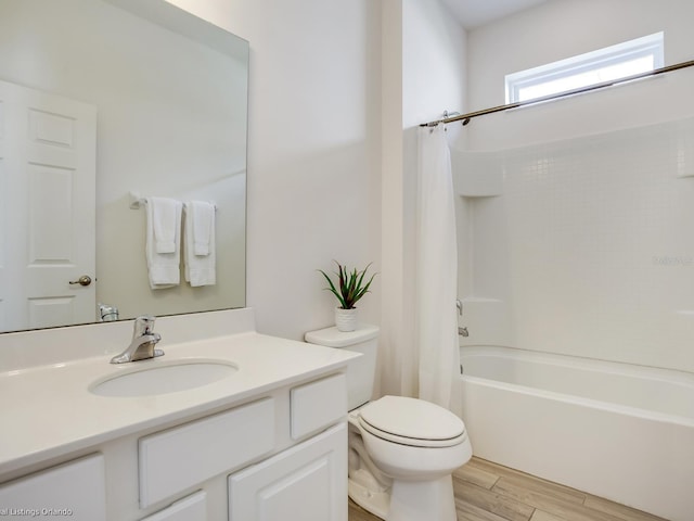 full bathroom featuring shower / bath combo, vanity, and toilet