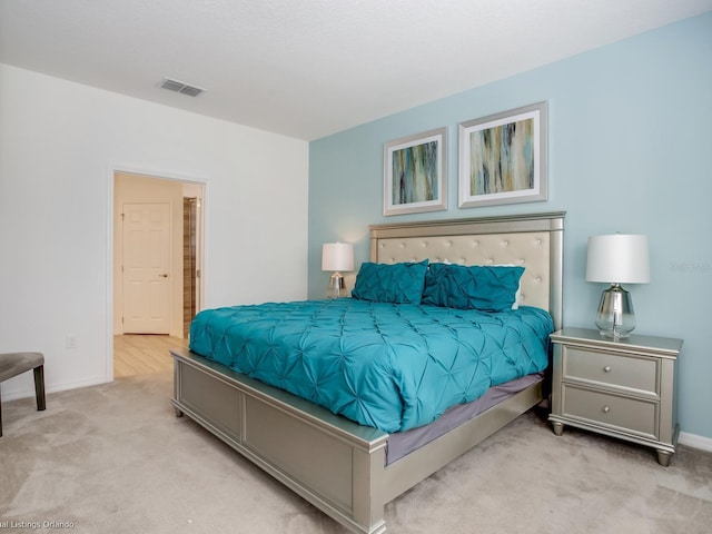 bedroom featuring light colored carpet