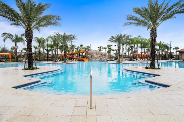 view of pool featuring a patio area and a water slide