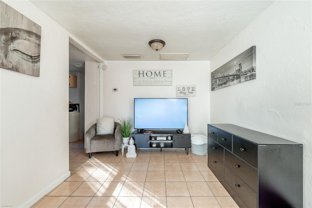 living room featuring light tile patterned flooring and a textured ceiling