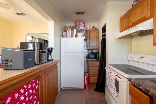 kitchen with light tile patterned floors, white appliances, and ornamental molding