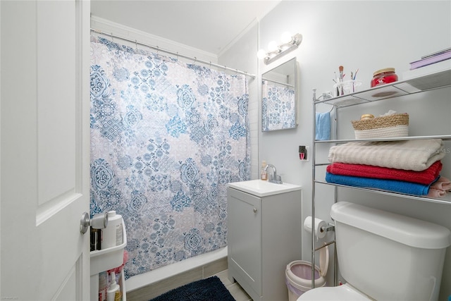 bathroom featuring tile patterned flooring, a shower with curtain, vanity, and toilet