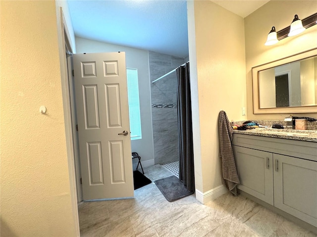 bathroom with vanity and tiled shower