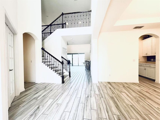 entrance foyer featuring a high ceiling and light wood-type flooring