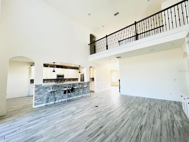 unfurnished living room with a towering ceiling