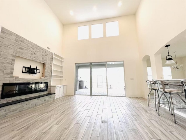 living room featuring a high ceiling and built in features