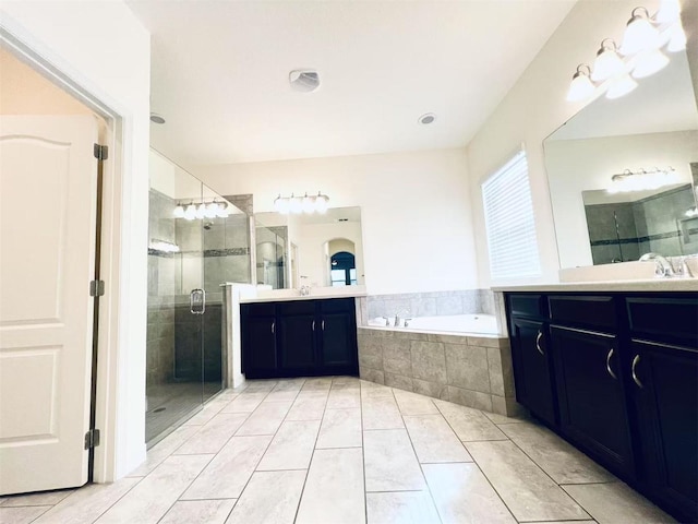 bathroom with tile patterned floors, vanity, and separate shower and tub