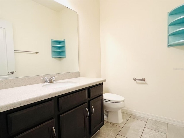 bathroom featuring tile patterned floors, vanity, and toilet