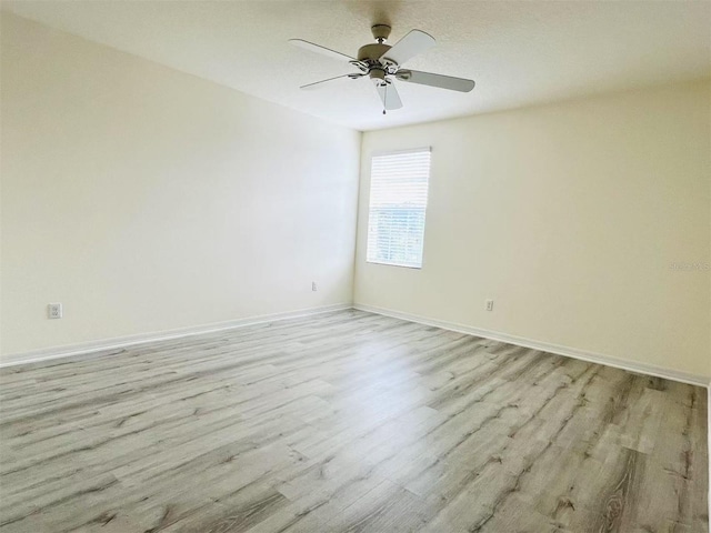 spare room featuring ceiling fan and light wood-type flooring