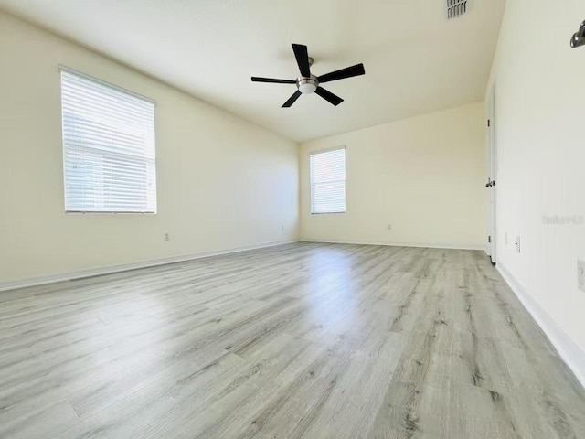 spare room with light wood-type flooring and ceiling fan