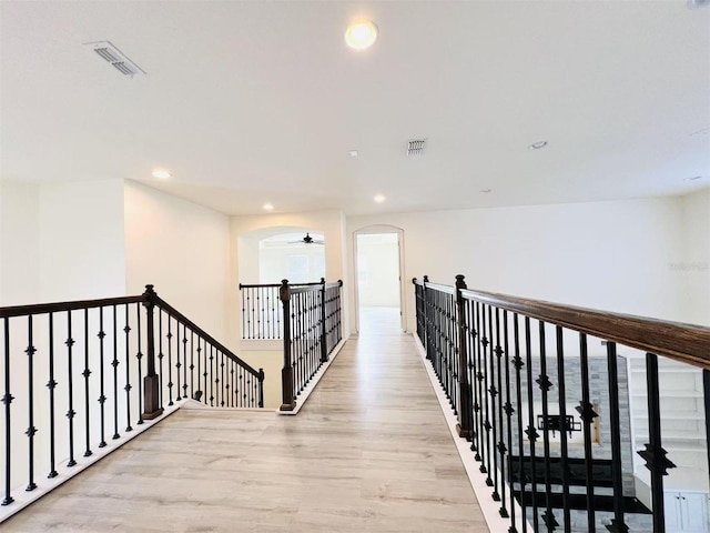 hallway with light hardwood / wood-style flooring