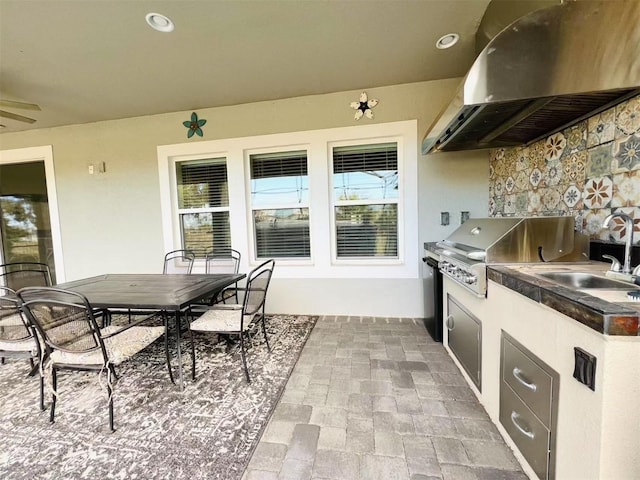 view of patio / terrace featuring grilling area, sink, and exterior kitchen