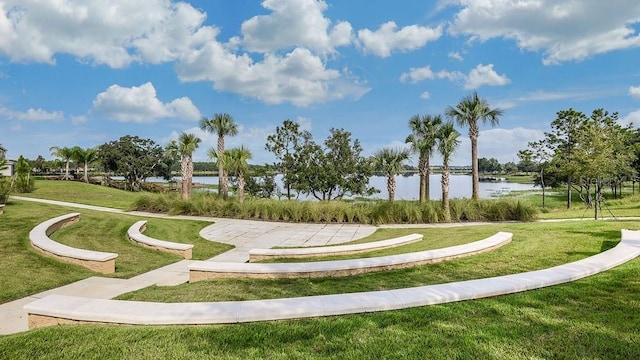 view of community with a yard and a water view