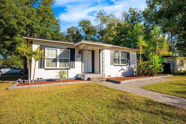 ranch-style home with a front lawn