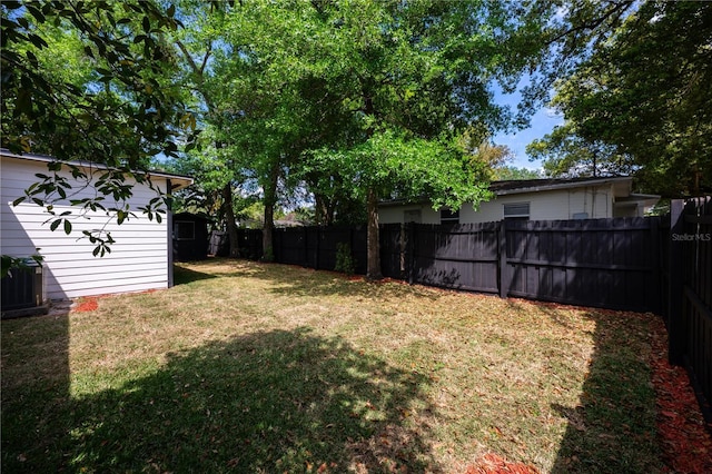 2803 E Pine St, Orlando, FL 32803 - view of yard featuring a fenced backyard, an outbuilding, central AC unit, and a storage shed