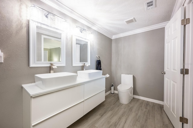 2803 E Pine St, Orlando, FL 32803 - bathroom with visible vents, a sink, and crown molding