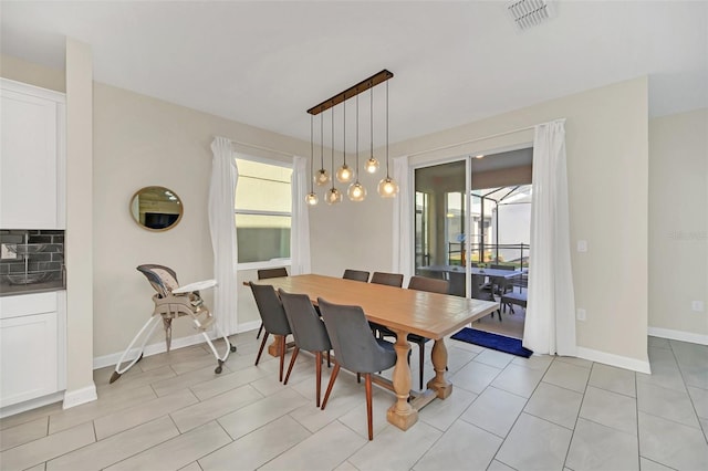 tiled dining room with a healthy amount of sunlight