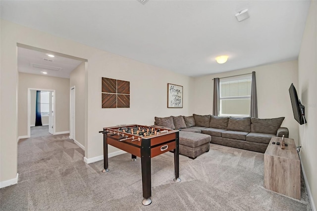 recreation room with light colored carpet