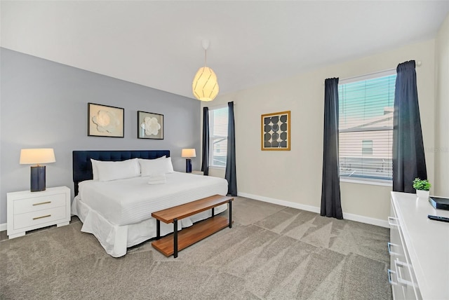 carpeted bedroom with multiple windows