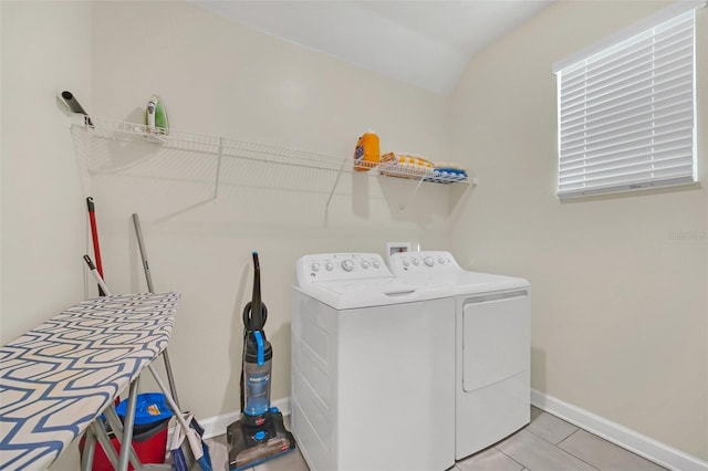 laundry area featuring light tile patterned floors and separate washer and dryer