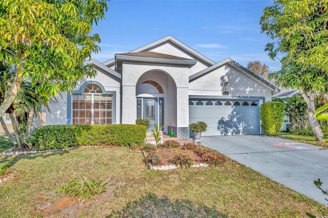 view of front of property featuring a garage and a front lawn