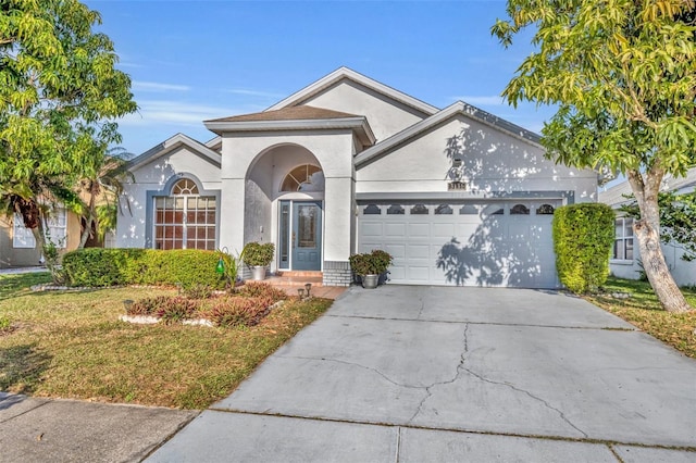 view of front facade with a front yard and a garage